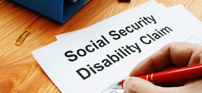 Man filling in Social Security Disability Claim.